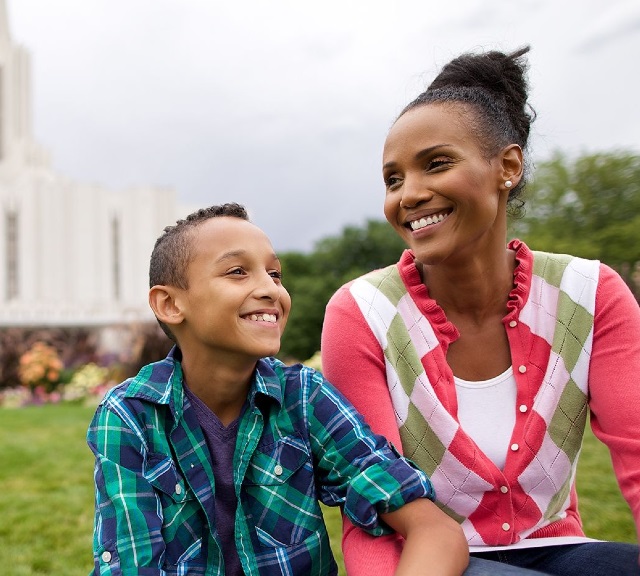 mother and son sitting outside temple